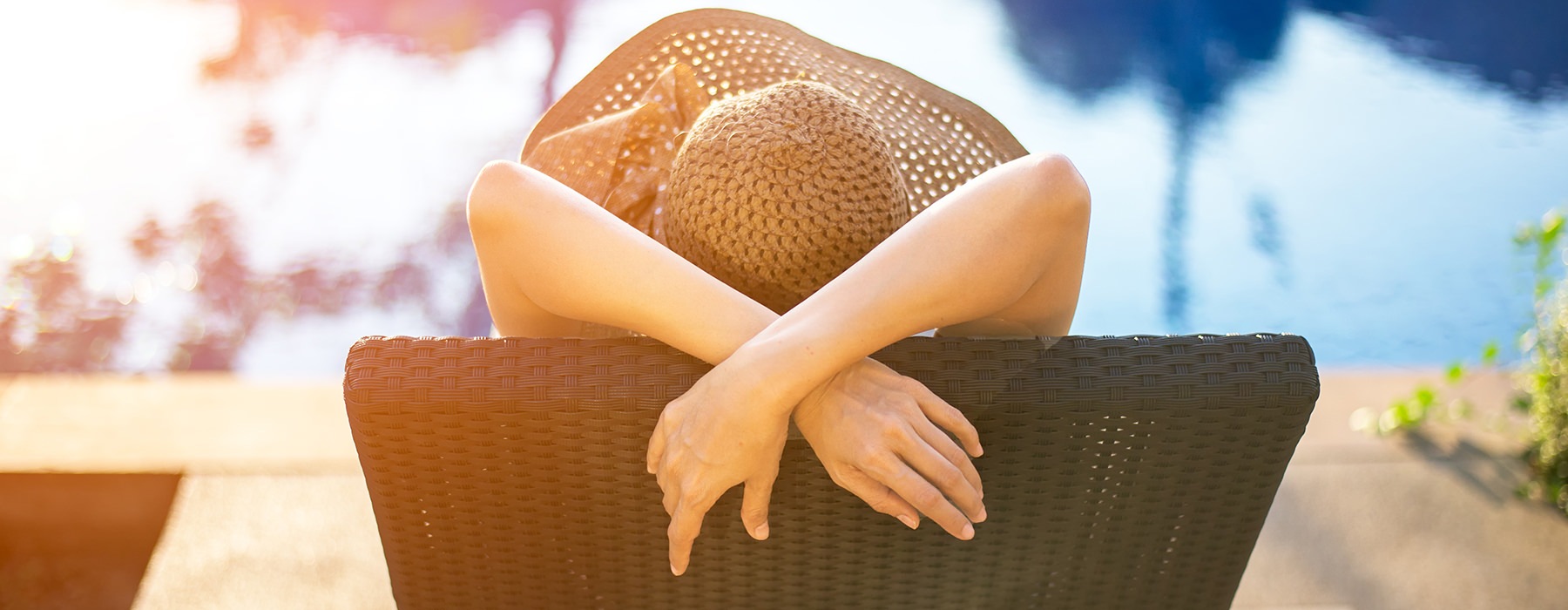 Woman relaxing on a lounge chair near the pool 