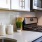 Spacious and well lit kitchen with wood floors and stainless steel appliances 