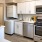 Spacious and well lit kitchen with wood floors and stainless steel appliances 