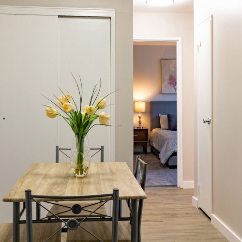 Spacious and well lit kitchen with wood floors and stainless steel appliances 