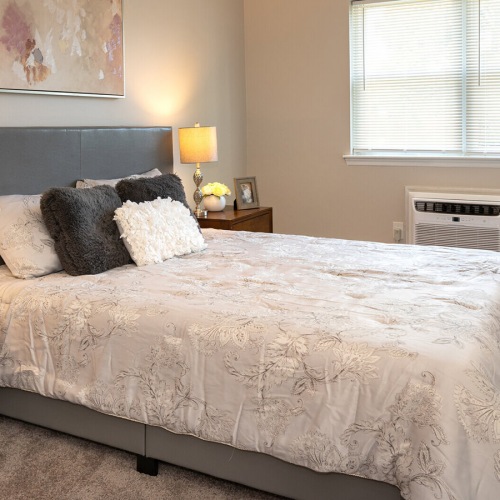 Large bedroom with wood floors and a large window